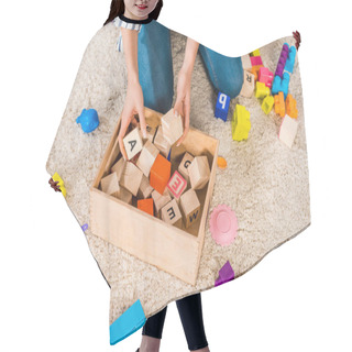 Personality  Cropped Image Of Woman Collecting Children Toys Hair Cutting Cape