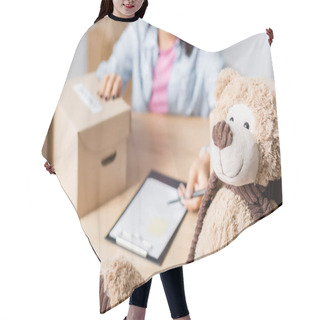 Personality  Soft Toy Near Volunteer With Boxes And Clipboard On Blurred Background  Hair Cutting Cape