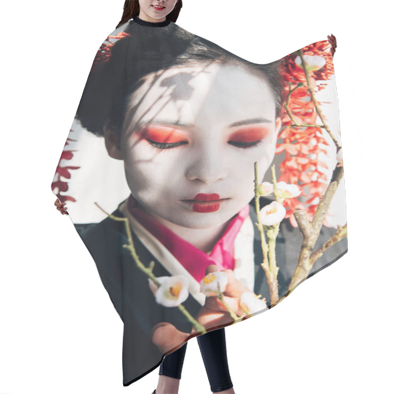 Personality  sakura branches and beautiful geisha with red and white makeup in sunlight hair cutting cape