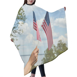Personality  Cropped View Of Young Woman Holding Two Small Flags In Hand On River And Forest Background Hair Cutting Cape