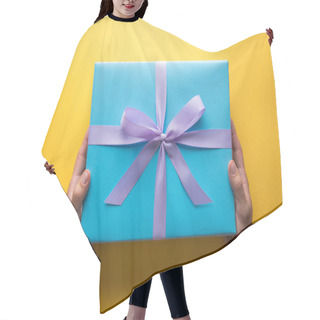 Personality  Cropped View Of Man Holding Blue Gift Box With Violet Ribbon On Yellow Background Hair Cutting Cape