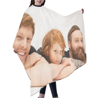 Personality  Joyful Man With Redhead Son And Bearded Tattooed Dad Lying With Crossed Arms And Smiling At Camera On Light Grey Background Hair Cutting Cape