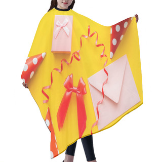 Personality  Top View Of Gift Box Near Envelope And Party Caps On Yellow Background  Hair Cutting Cape