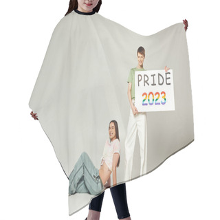 Personality  Happy Gay Man Holding Pride 2023 Placard While Standing Next To Smiling Queer Friend With Bare Belly And Celebrating Lgbtq Community Holiday In June On Grey Background In Studio  Hair Cutting Cape