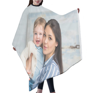 Personality  Portrait Of Young Mother Holding Cheerful Adorable Baby Boy In Hands At Home Hair Cutting Cape
