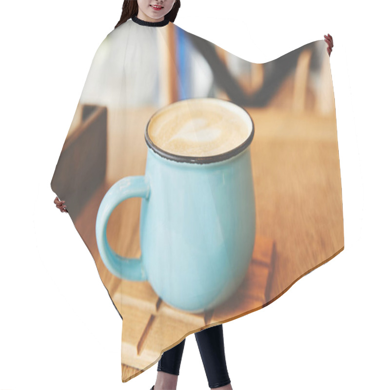 Personality  Hot cappuccino in blue mug on table hair cutting cape