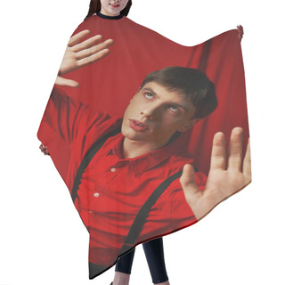 Personality  Young Suspenseful Man In Shirt With Suspenders Posing With Raised Hands On Red Background, Startled Hair Cutting Cape