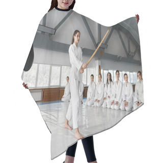 Personality  Young Girl Fighting With Wooden Sword At Aikido Training In Martial Arts School. Teenage Female Fighter In White Kimono Showing Technique To Her Classmates Hair Cutting Cape