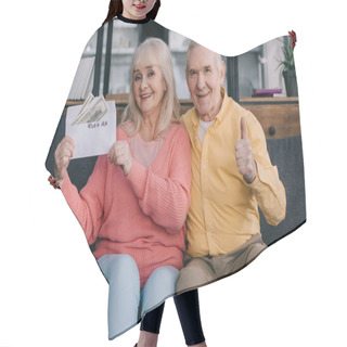 Personality  Senior Couple Showing Thumb Up Sign While Holding Envelope With 'roth Ira' Lettering And Dollar Banknotes Hair Cutting Cape