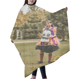 Personality  Girl In Halloween Costume Holding Diy Spooky Decoration Near Pumpkin, Pointed Hat And Candy Bucket Hair Cutting Cape