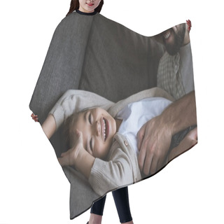 Personality  Father With Daughter Laying On Couch, Hugging And Laughing At Home Hair Cutting Cape