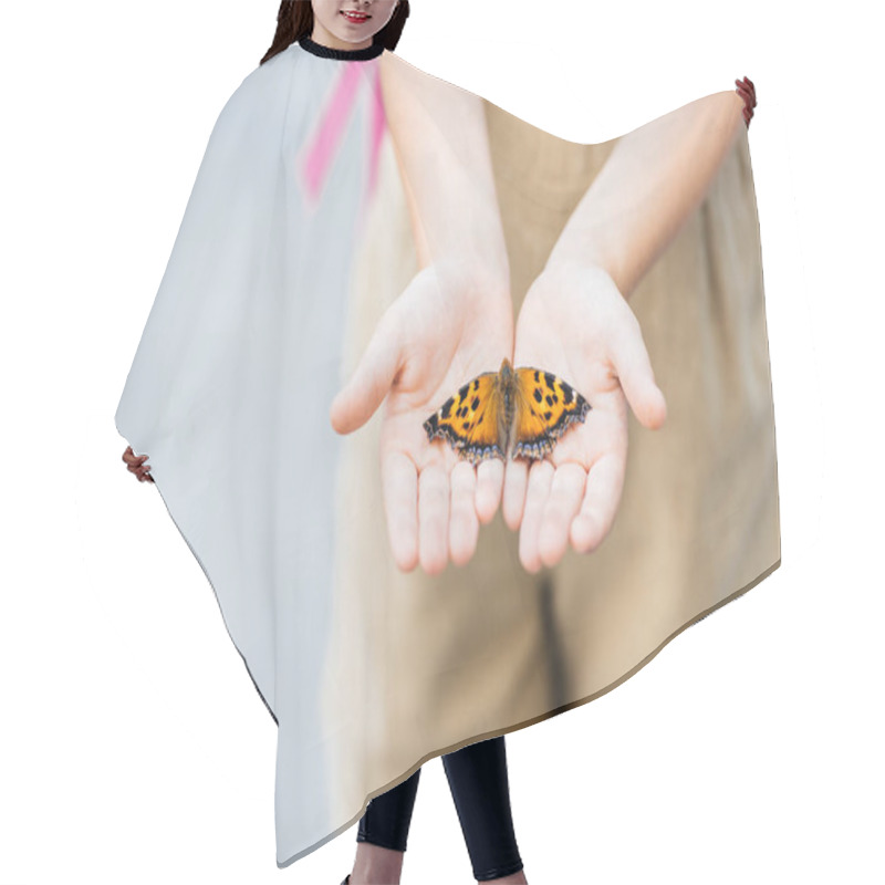 Personality  cropped shot of little child holding butterfly in hands hair cutting cape