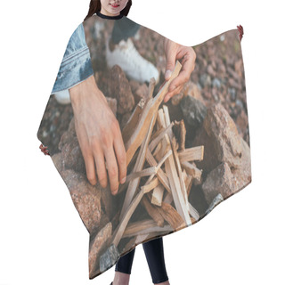 Personality  Cropped View Of Young Man Touching Sticks While Making Bonfire Near Stones  Hair Cutting Cape