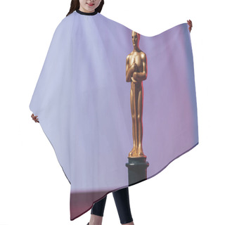 Personality  KYIV, UKRAINE - JANUARY 10, 2019: Golden Oscar Award On Purple Background With Copy Space Hair Cutting Cape