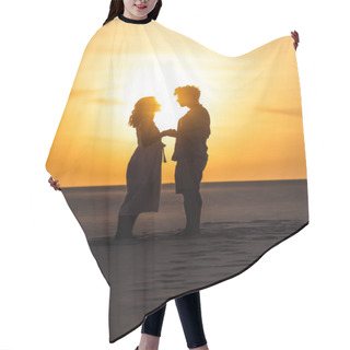 Personality  Side View Of Silhouettes Of Man And Woman Holding Hands On Beach Against Sun During Sunset Hair Cutting Cape