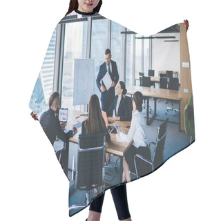 Personality  Adult Entrepreneur In Formal Wear Standing In Conference Room And Talking With Colleagues Sitting At Table While Discussing Strategies Of Company Hair Cutting Cape