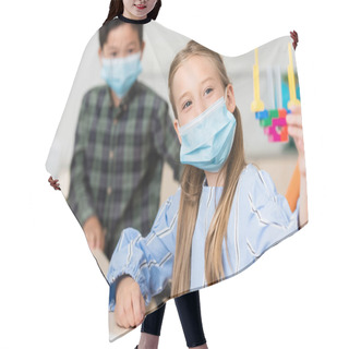 Personality  Selective Focus Of Schoolgirl In Medical Mask Holding Building Blocks Near Asian Classmate In School  Hair Cutting Cape
