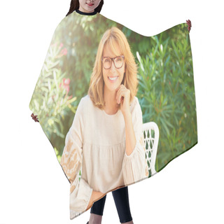 Personality  Portrait Of Happy Middle Aged Woman Wearing Casual Clothes And Looking At Camera While Sitting In The Garden And Relaxing. Hair Cutting Cape
