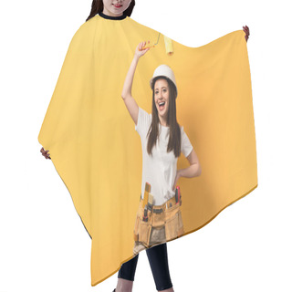 Personality  Smiling Handywoman With Hand On Hip Holding Paint Roller On Yellow Background  Hair Cutting Cape