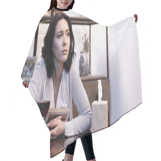Personality  Upset Woman Sitting On Table And Crying With Photo Frame In Hands At Home Hair Cutting Cape