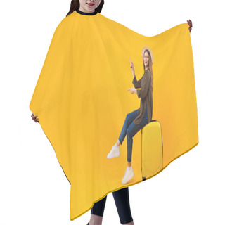Personality  Female Tourist Pointing Fingers Aside Sitting On Suitcase, Yellow Background Hair Cutting Cape
