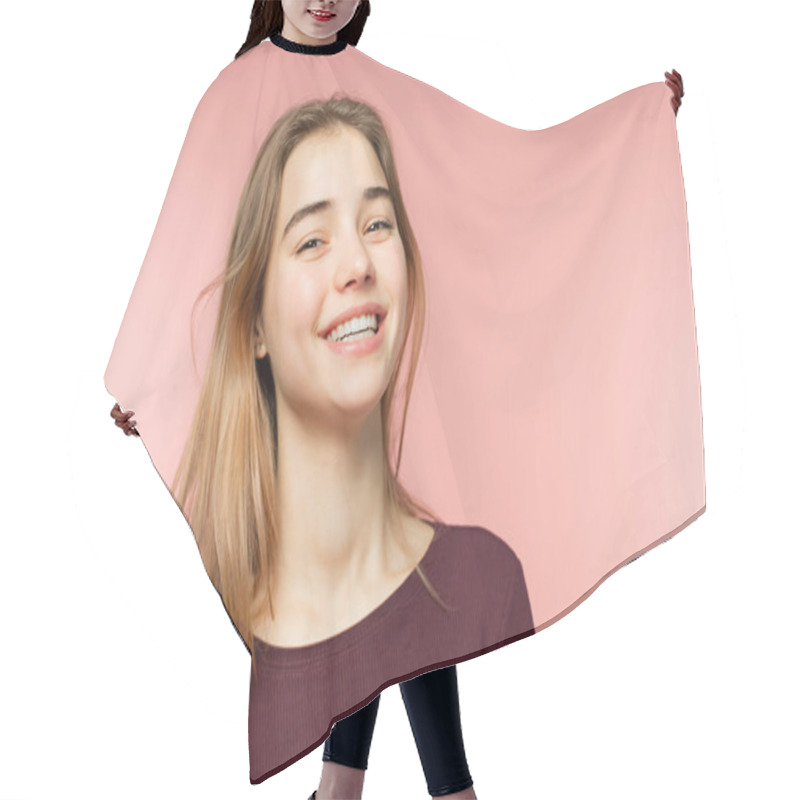 Personality  Woman smiling with perfect smile and white teeth on the pink studio background and looking at camera hair cutting cape