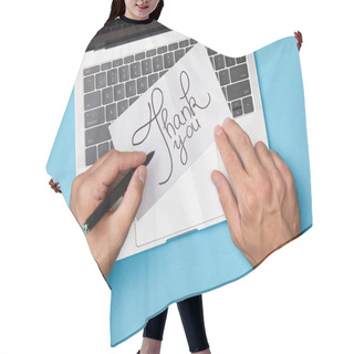 Personality  Cropped View Of Man Writing On Card With Thank You Lettering Near Laptop On Blue Background Hair Cutting Cape