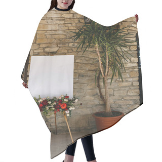 Personality  Easel With A White Blank Welcome Board A Floral Arrangement At A Wedding. Hair Cutting Cape