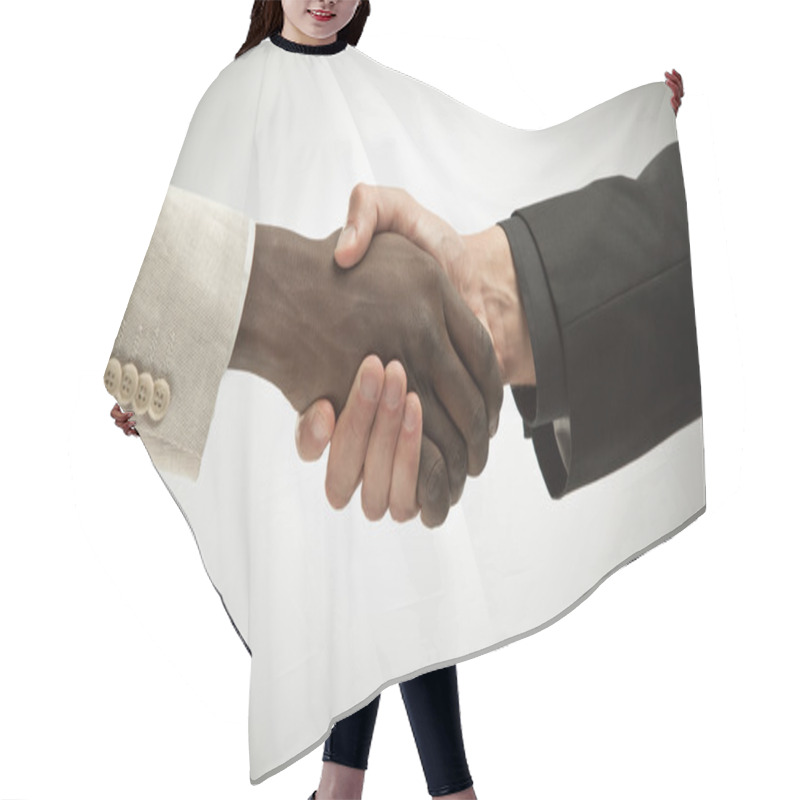 Personality  black and white interracial handshake isolated on grey hair cutting cape