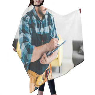 Personality  Cropped View Of Bearded Worker Writing While Holding Clipboard  Hair Cutting Cape