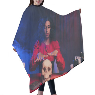 Personality  Brunette Oracle During Magic Session Near Skull And Burning Candles On Dark Background With Blue Smoke Hair Cutting Cape