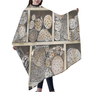 Personality  Bug Hotel In A Wooden Frame For Insects To Breed And Overwinter In With Holes Drilled In Logs, Grass Stems And Bamboo Canes. Hair Cutting Cape
