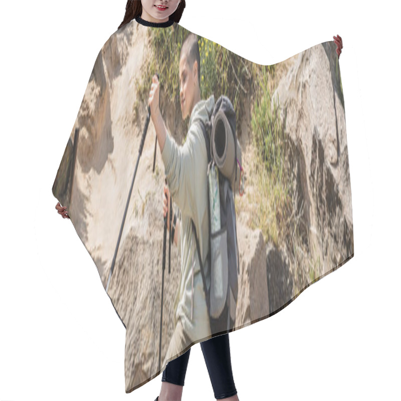 Personality  Short Haired Woman Traveler In Casual Clothes With Backpack Holding Trekking Poles While Standing Near Hill With Stones At Background, Tranquil Hiker Finding Inner Peace On Trail, Banner  Hair Cutting Cape