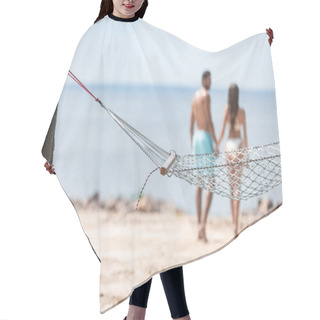 Personality  Selective Focus Of Couple Holding Hands And Walking On Beach With Hammock On Foreground Hair Cutting Cape