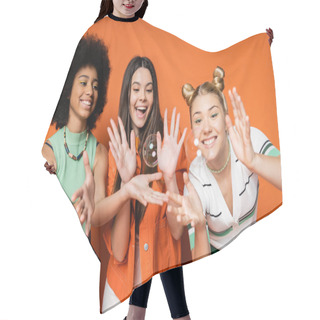 Personality  Cheerful And Multiethnic Teen Girlfriends In Stylish Casual Clothes Looking At Soap Bubbles While Standing On Orange Background, Teen Fashionistas With Impeccable Style Concept Hair Cutting Cape