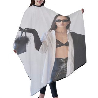 Personality  Edgy Style, Studio Photography, Young Asian Woman In Stylish Look And Sunglasses Posing With Feathered Handbag On Grey Background, Model In Blazer And Latex Shorts, Youthful Fashion  Hair Cutting Cape