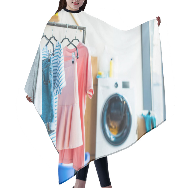 Personality  clothes on hangers and washing machine at home hair cutting cape