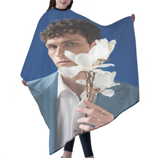Personality  Trendy Young Man In Jacket And Shirt Holding Magnolia Flowers Isolated On Blue  Hair Cutting Cape