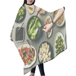 Personality  Vegan Dinner Table Setting. Healthy Vegetarian Dishes In Plates On Table. Flat-lay Of Vegetables, Legumes, Beans, Olives, Sprouts, Hummus, Couscous And Female Hands Taking Salad From Bowl, Top View Hair Cutting Cape
