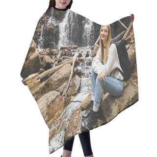 Personality  Adventurous Woman Hiker Sitting With Backpack And Looking At Camera In Forest Near Waterfall Hair Cutting Cape