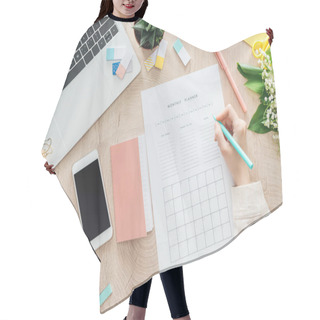 Personality  Cropped View Of Woman Sitting Behind Wooden Table With Smartphone, Laptop And Stationery, Writing In Monthly Planner Hair Cutting Cape