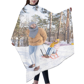 Personality  Smiling Man Pulling Sleigh With Girlfriend In Winter Park  Hair Cutting Cape