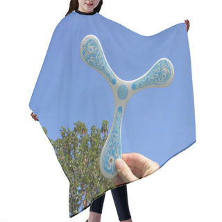 Personality  Man's Hand With Plastic Boomerang Read To Flight On A Blue Sky. Hair Cutting Cape
