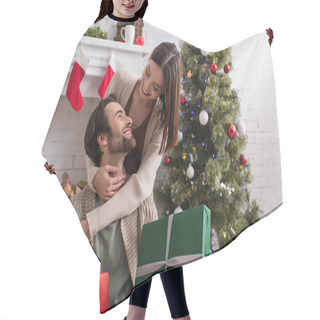 Personality  Pleased Woman Embracing Husband Holding Gift Boxes Near Fireplace And Christmas Tree Hair Cutting Cape