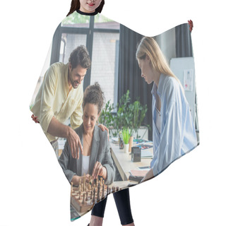 Personality  Smiling Businessman Pointing With Finger At Chess Near Interracial Colleagues In Office  Hair Cutting Cape