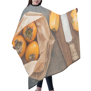 Personality  Top View Of Whole Persimmons In Paper Packet And Sliced On Cutting Board  Hair Cutting Cape