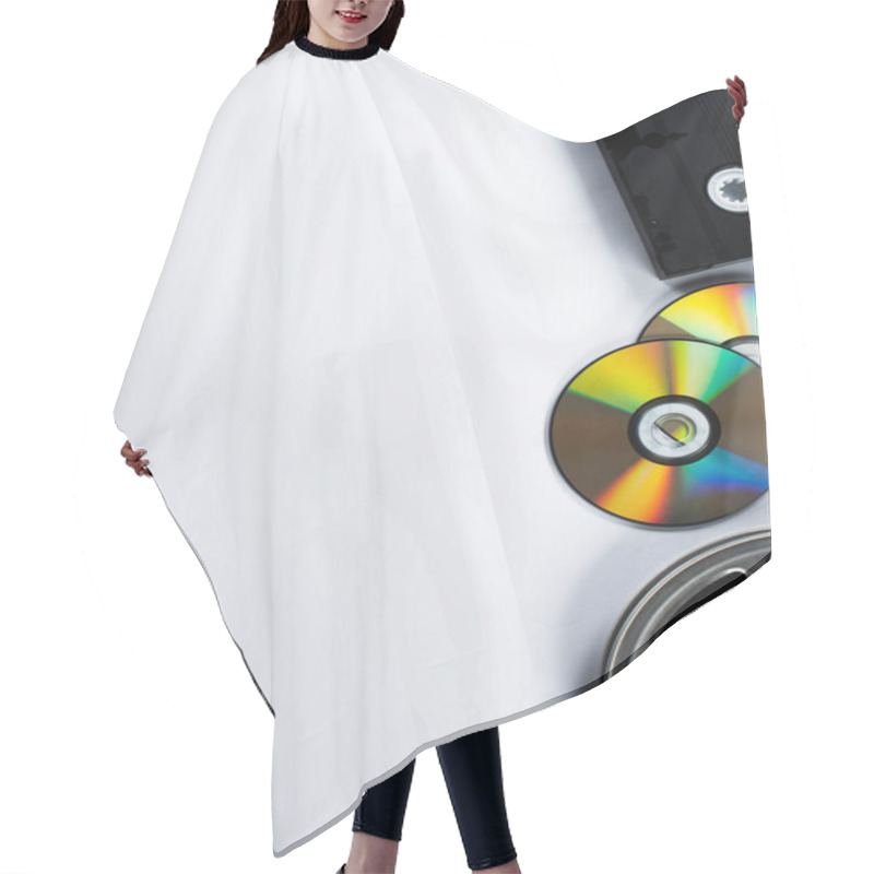 Personality  Top View Of CD Discs, VHS Cassette And Film Reel On White Background Hair Cutting Cape