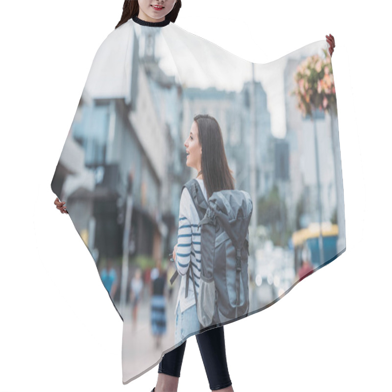 Personality  Back view of woman with backpack walking on street hair cutting cape
