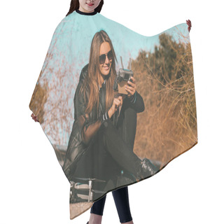 Personality  Young Modern Woman In Stylish Dark Clothes And Sunglasses Preparing To Start Flying Drone On Sunset Or Sunrise. Hair Cutting Cape