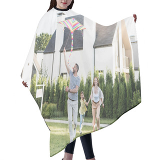 Personality  Full Length Of Happy Man Flying Kite Near Woman And Girl On Lawn Near Houses Hair Cutting Cape